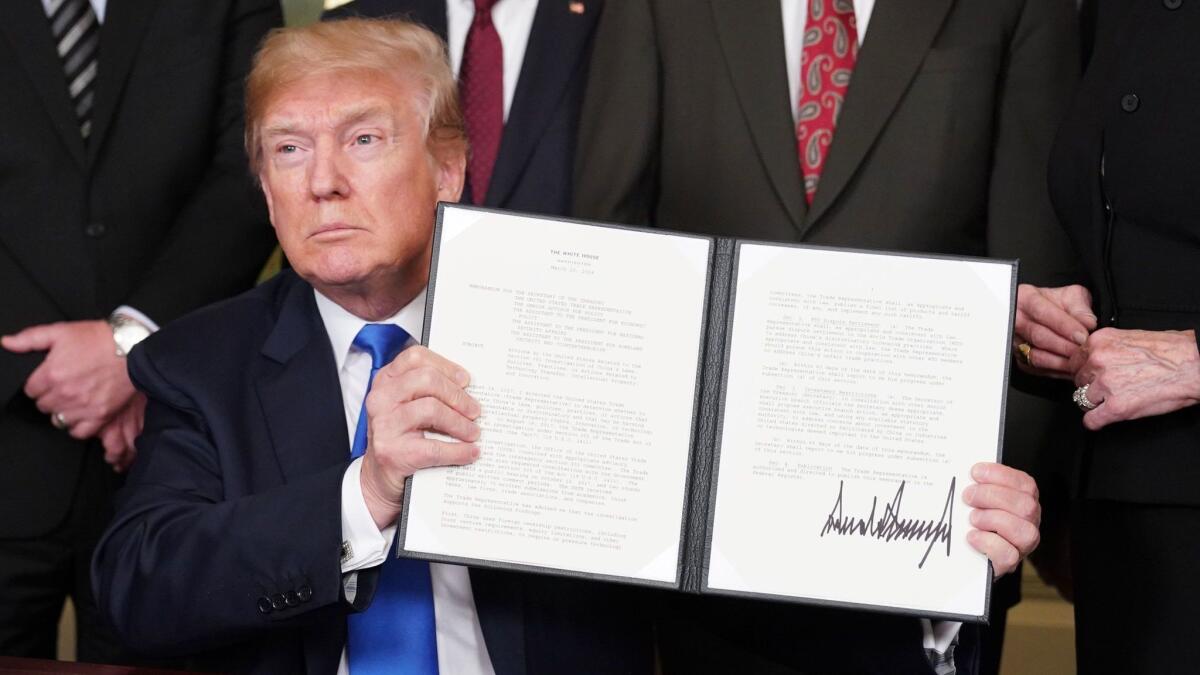 President Trump signed trade sanctions against China at the White House on March 22, 2018.