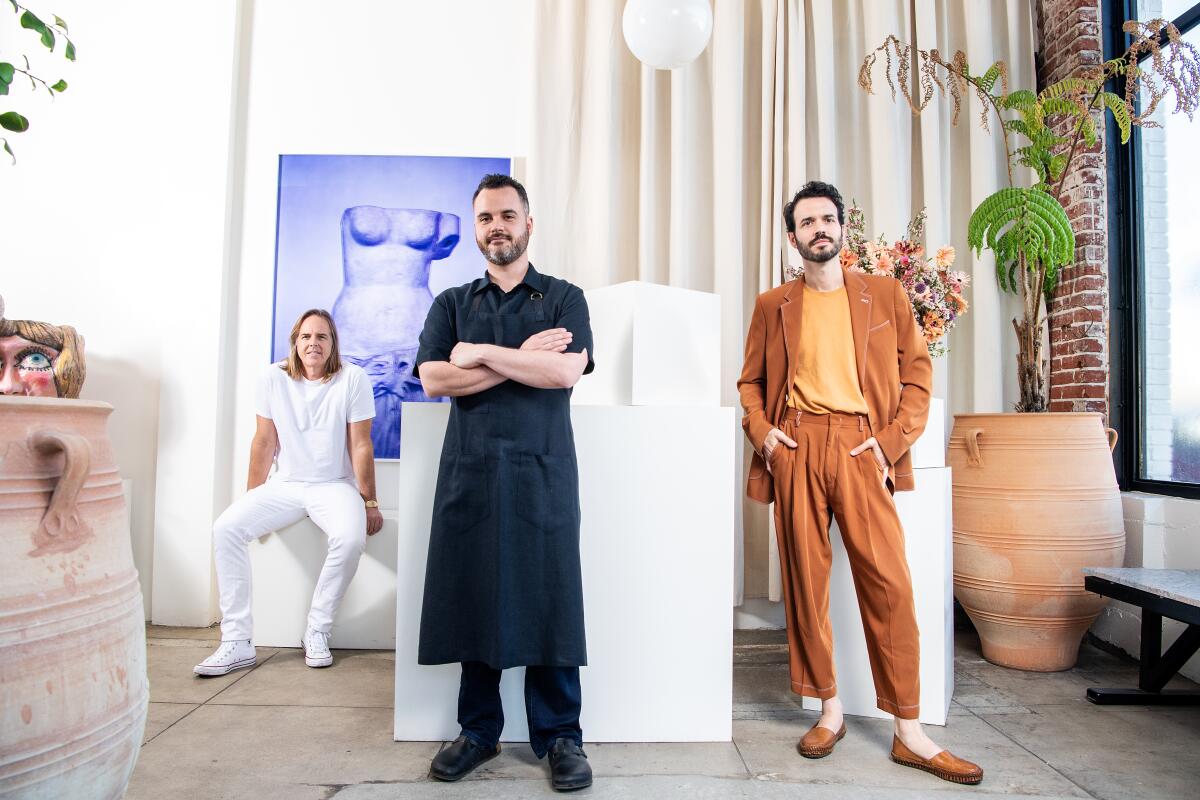 Bar Restaurant owner Ellermeyer, chef Douglas Rankin and and general manager Pierluc Dallaire stand in front of dining room art culled from Ellermeyer's personal collection.