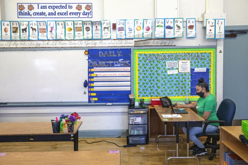 LOS ANGELES, CA -AUGUST 19, 2020: Gladys Alvarez, a 5th grade teacher at Manchester Ave. Elementary School in South Los Angeles, talks to her students during a meet and greet on Wednesday afternoon. Alvarez was sitting inside her empty classroom while conducting the virtual zoom class. (Mel Melcon / Los Angeles Times)
