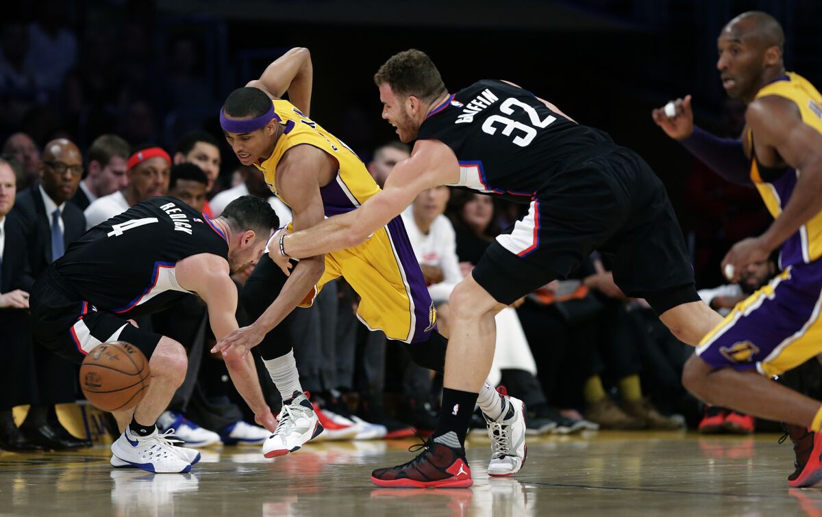 Lakers guard Jordan Clarkson steals the ball from the Clippers' J.J. Redick, left, and Blake Griffin during a game at Staples Center.