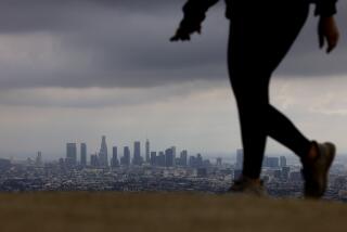 LOS ANGELES-CA-FEBRUARY 29 , 2024: A view of downtown Los Angeles is seen from Runyon Canyon, a popular hiking spot in Los Angeles, on February 29, 2024. The Los Angeles City Council established new parking restrictions (permit exempt) for residential streets surrounding Runyon Canyon. (Christina House / Los Angeles Times)
