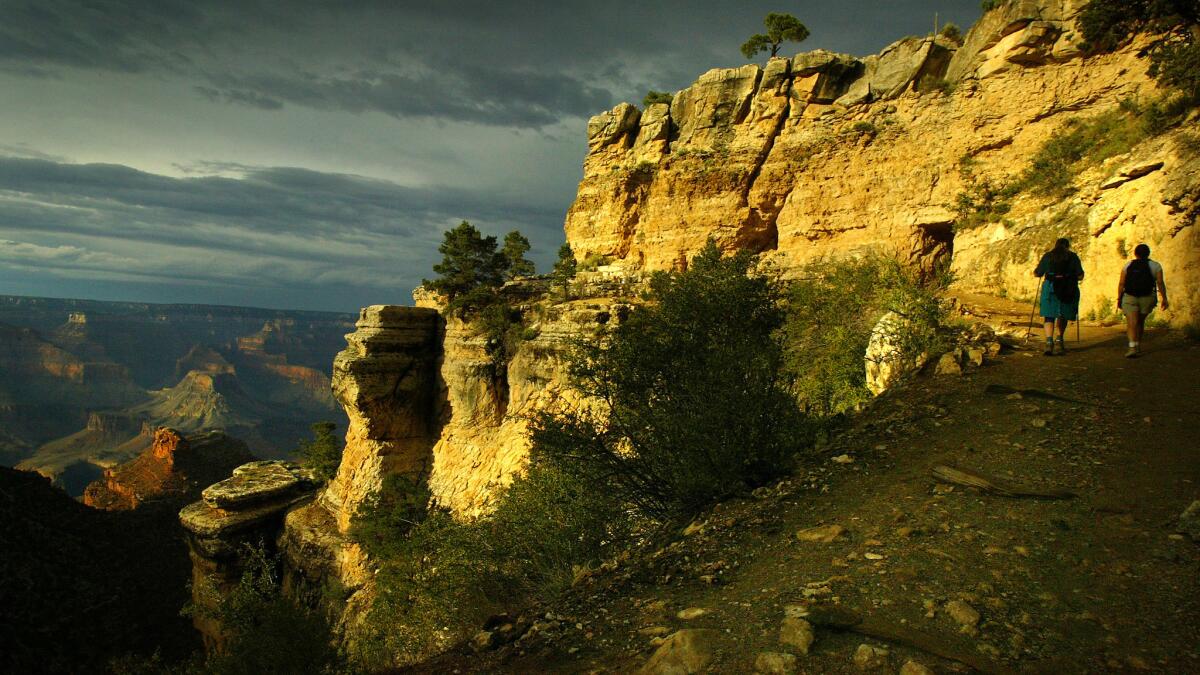 Hikers walk along the Bright Angel Trail in Arizona's Grand Canyon National Park.