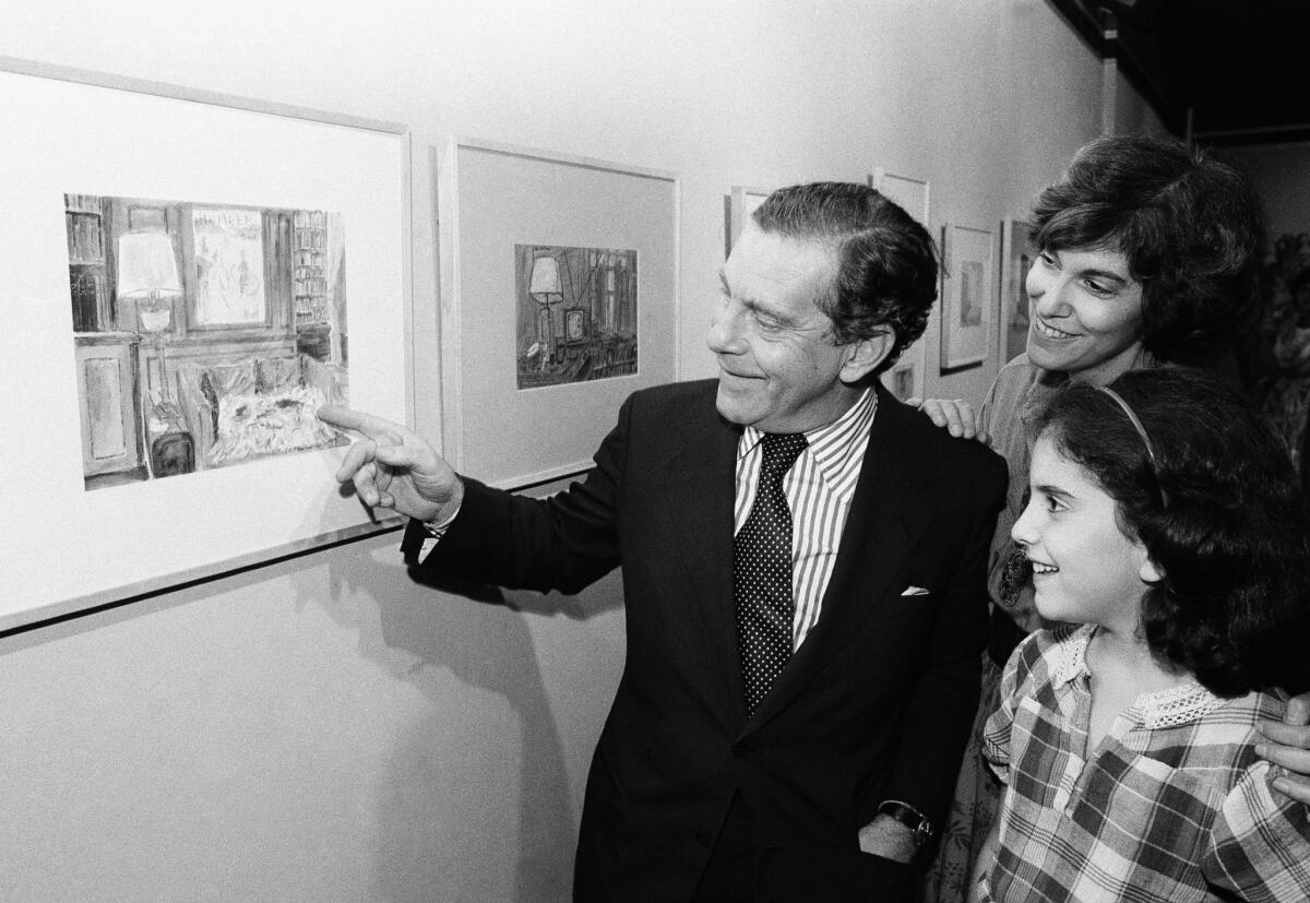 Morley Safer points to one of his watercolors displayed at a New York restaurant in 1980.