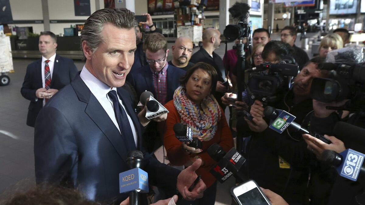 Gov. Gavin Newsom says California will offer unemployment benefits to federal employees working without pay after meeting with TSA workers at Sacramento International Airport on Thursday.