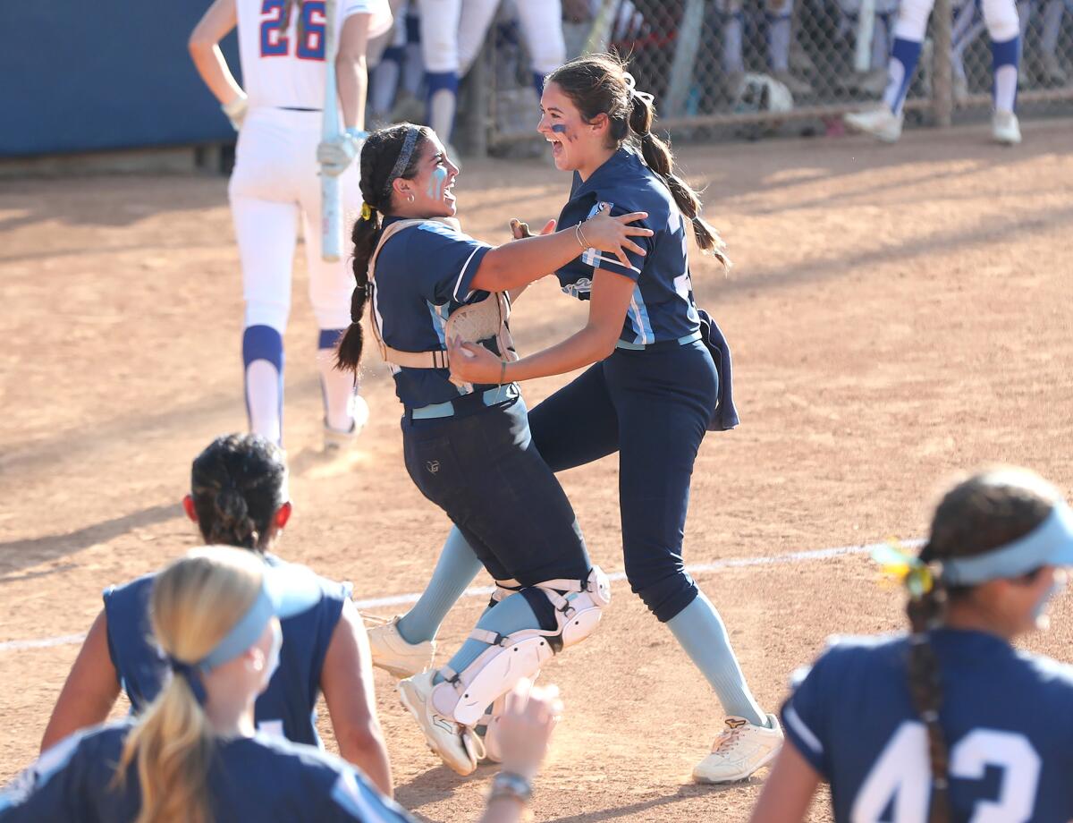 Marina catcher Gabby DiBenedetto and pitcher Mia Valbuena (34) celebrate the final out.