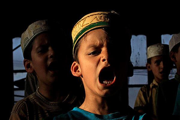 A Kashmiri boy recites verses from the Koran at a local seminary. Muslims throughout the world are marking the holy month of Ramadan, during which they fast from dawn till dusk.