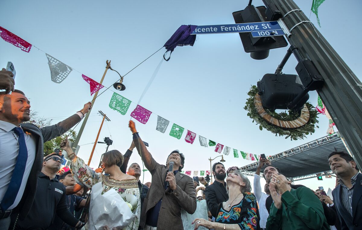 People looking up during a celebration at an intersection