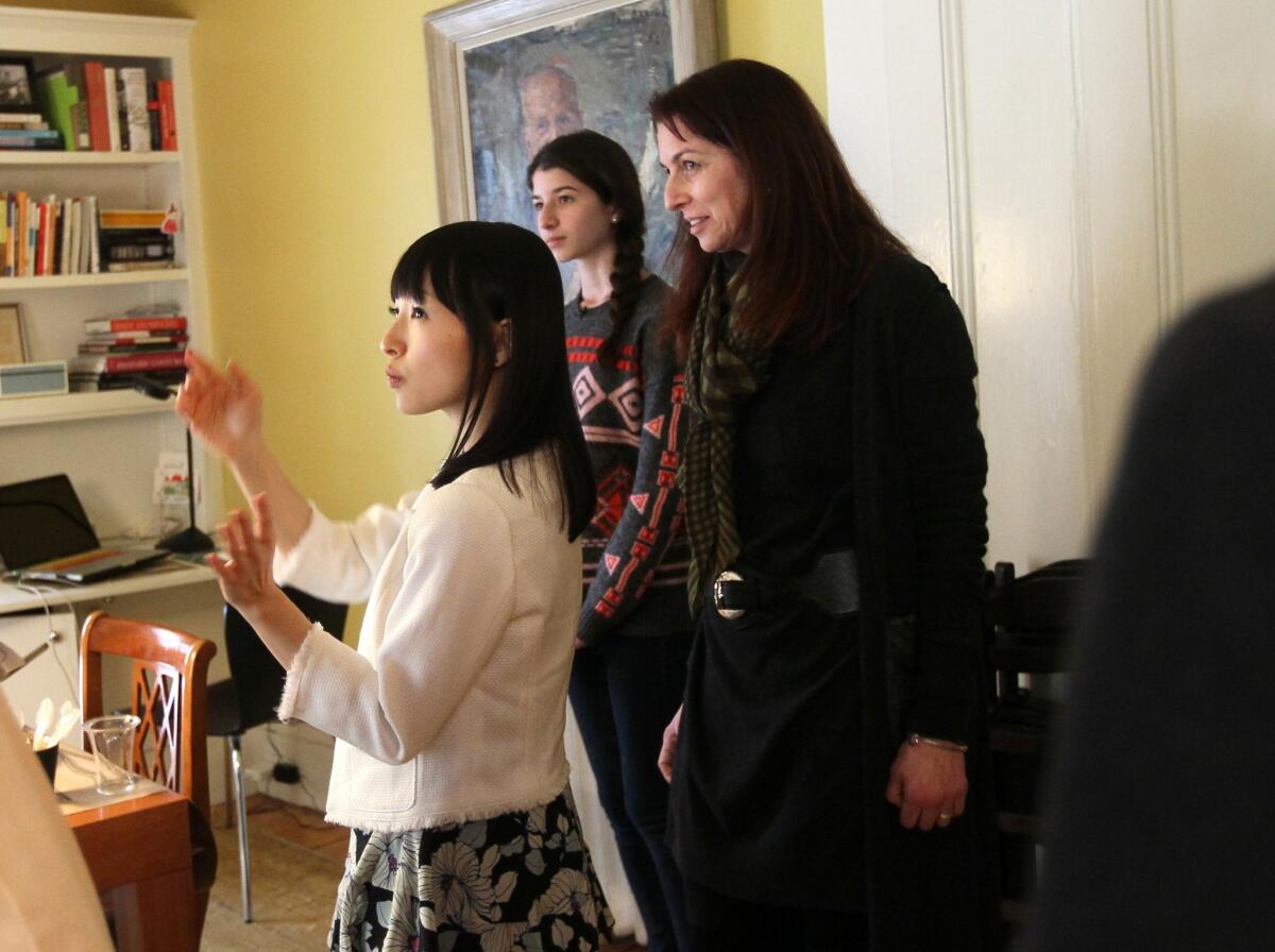 Marie Kondo, left, author and tidiness guru, tells Claudia Logan and her daughter, Otti, that there is much joy in their dining room/office.