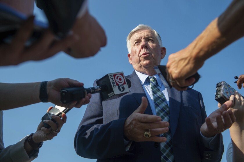 Missouri Gov. Mike Parson answers media's questions after he signed a bill to increase the state's gas tax on Tuesday, July 13, 2021, at the Buck O'Neil Bridge in Kansas City, Mo. It's the first gas tax increase for Missourians in decades. (Shelly Yang/The Kansas City Star via AP)