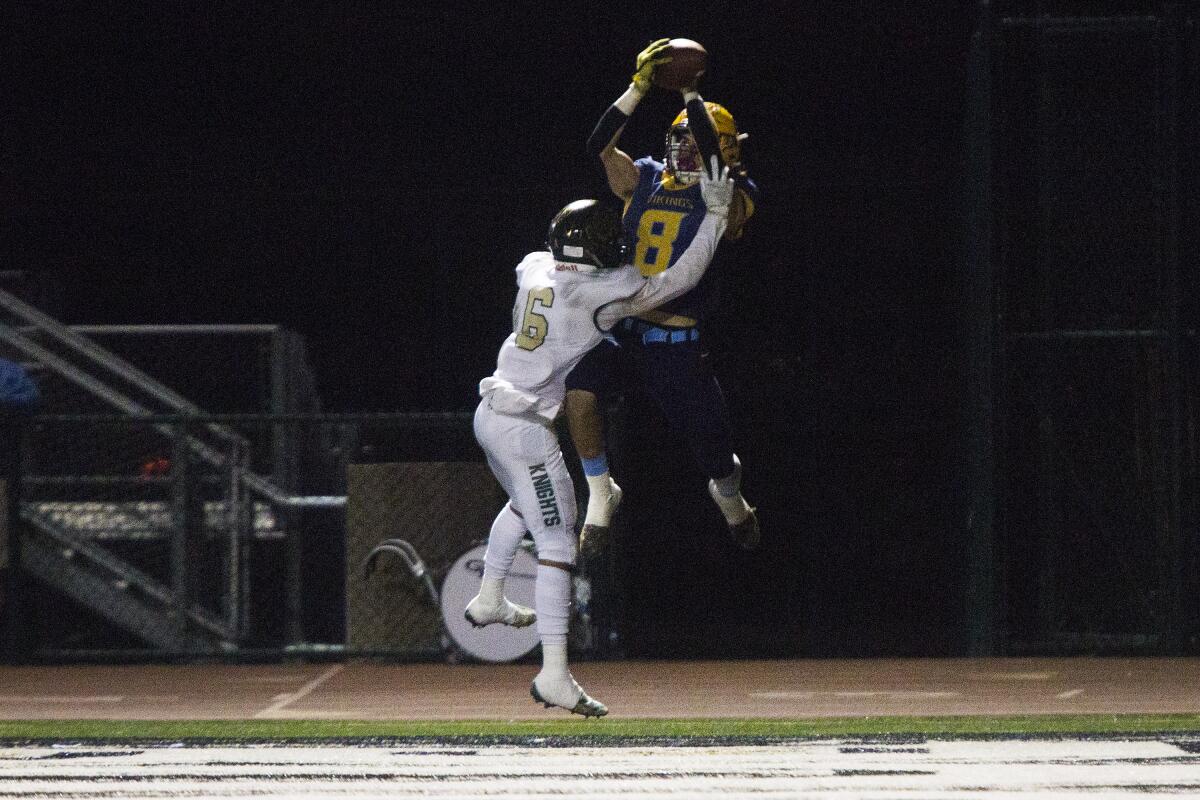 Marina’s Dane Brenton catches a 13-yard touchdown against Ontario Christian’s Alvis Nuno in the quarterfinals of the CIF Southern Section Division 11 playoffs on Nov. 15 at Westminster High.