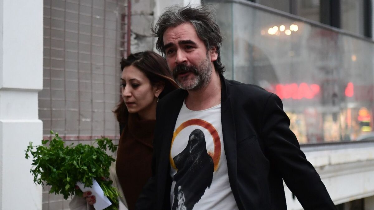 German Turkish journalist Deniz Yucel arrives at his home with his wife Dilek Mayaturk in Istanbul on Friday after his release from prison.