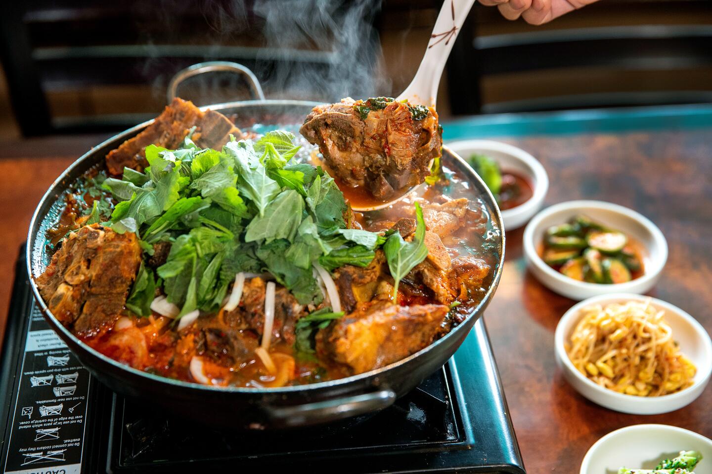 GARDEN GROVE, CALIF. -- WEDNESDAY, NOVEMBER 20, 2019: A detail of Korean pork neck stew at Gamja Tang House in Garden Grove, Calif., on Nov. 20, 2019. (Allen J. Schaben / Los Angeles Times)