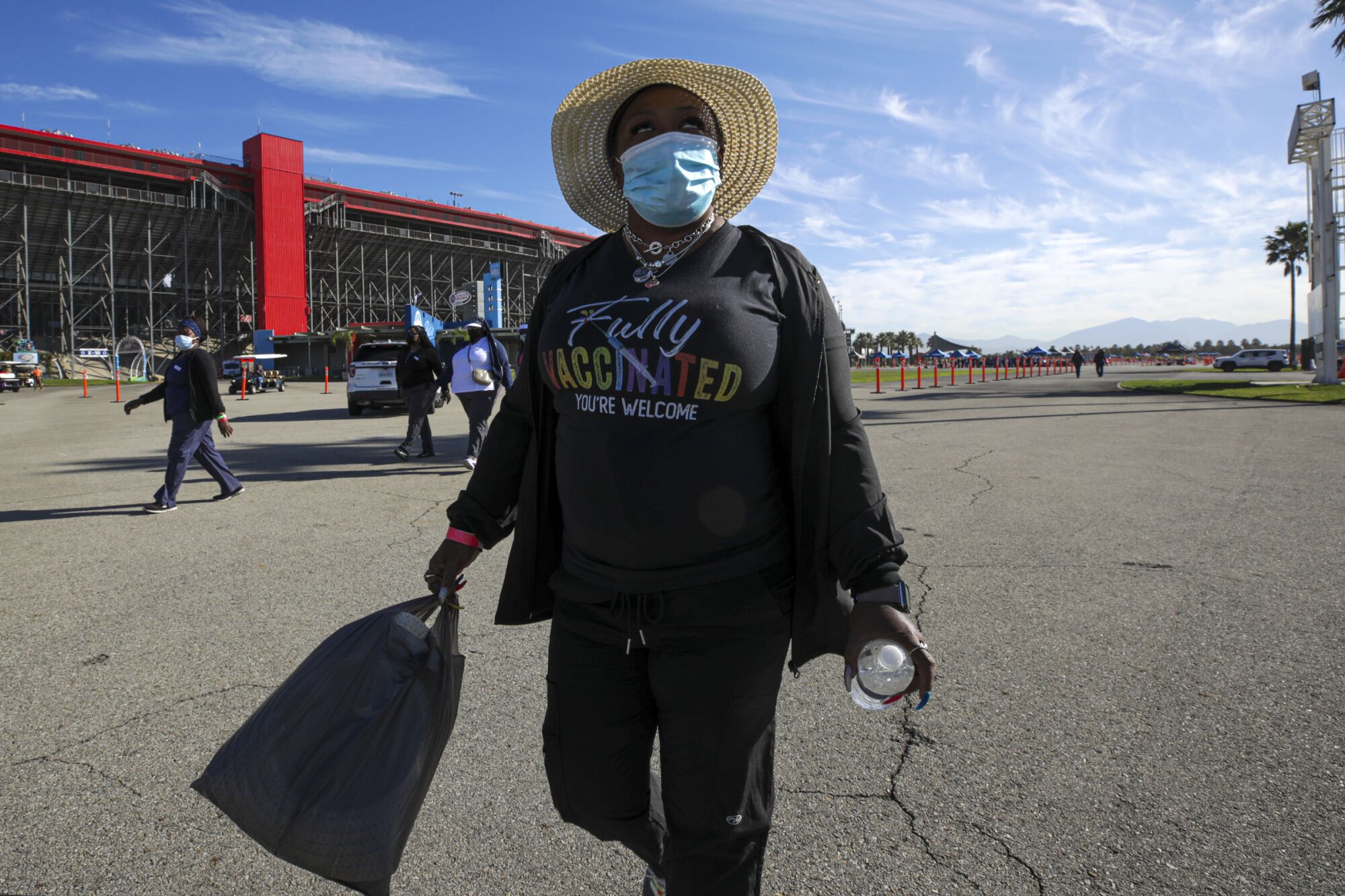 Travel nurse Reshicka Upshaw arrives for duty at a mass vaccination site at Auto Club Speedway in Fontana.