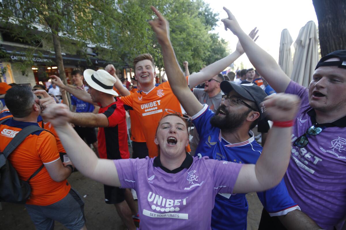 Glasgow Rangers supporters shout and cheer outside a bar in downtown Seville, Spain, Tuesday, May 17, 2022. Eintracht Frankfurt will play Glasgow Rangers in the Europa League final Wednesday evening in Seville. (AP Photo/Angel Fernandez)