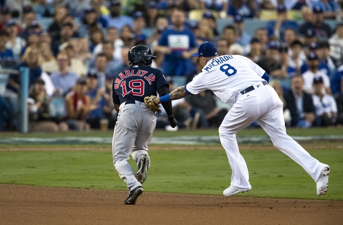 Dodgers shortstop Manny Machado tags out Red Sox center fielder Jackie Bradley Jr. who was attempting to steal in the third inning.