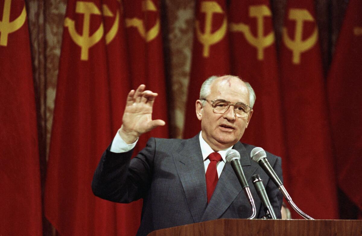 Mikhail Gorbachev speaks at a lectern in 1990.