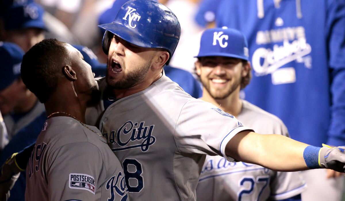 Royals third baseman Mike Moustakas (8) celebrates in the dugout after his solo home run in the 11th inning provided Kansas City with a 3-2 victory over the Angels in Game 1 of their American League division series on Thursday night in Anaheim.