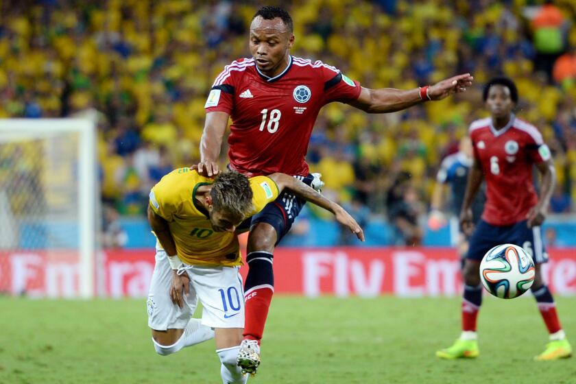 Colombia's Juan Zuniga, top, makes contact with Brazil star Neymar during Brazil's World Cup quarterfinal win on Friday. Neymar suffered a fractured vertebra on the play, but FIFA announced Monday it will not impose disciplinary action upon Zuniga.