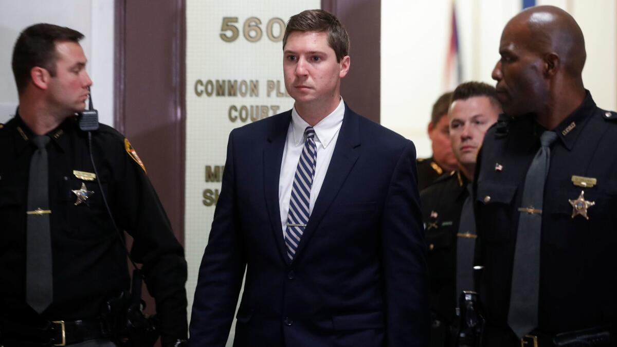 In this Nov. 11, 2016, photo, former University of Cincinnati police officer Ray Tensing, center, leaves court during jury deliberations in his murder trial.