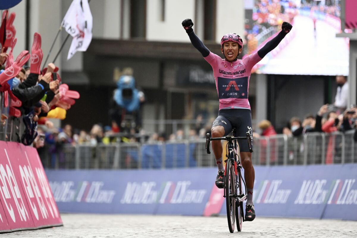Colombia's Egan Bernal celebrates as he crosses the finish line to win the 16th stage of the Giro d'Italia cycling race, from Sacile to Cortina D'Ampezzo, northern Italy, Monday, May 24, 2021. (Massimo Paolone/LaPresse via AP)