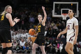 Iowa's Caitlin Clark, with the ball, reacts after she was fouled late in the game against South Carolina on March 31, 2023.
