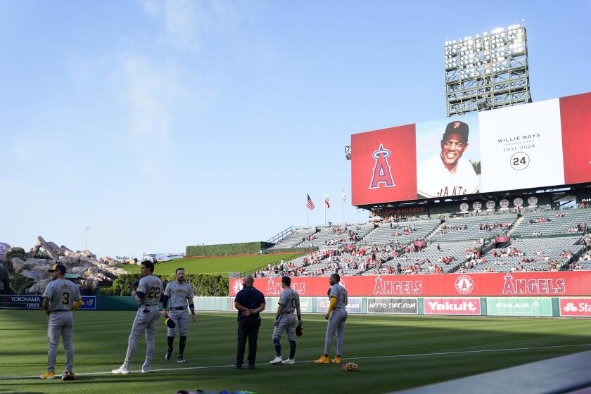 Milwaukee Brewers players stand during a moment of silence in honor of the passing of Willie Mays before a baseball game against the Los Angeles Angels, Wednesday, June 19, 2024, in Anaheim, Calif. (AP Photo/Ryan Sun)