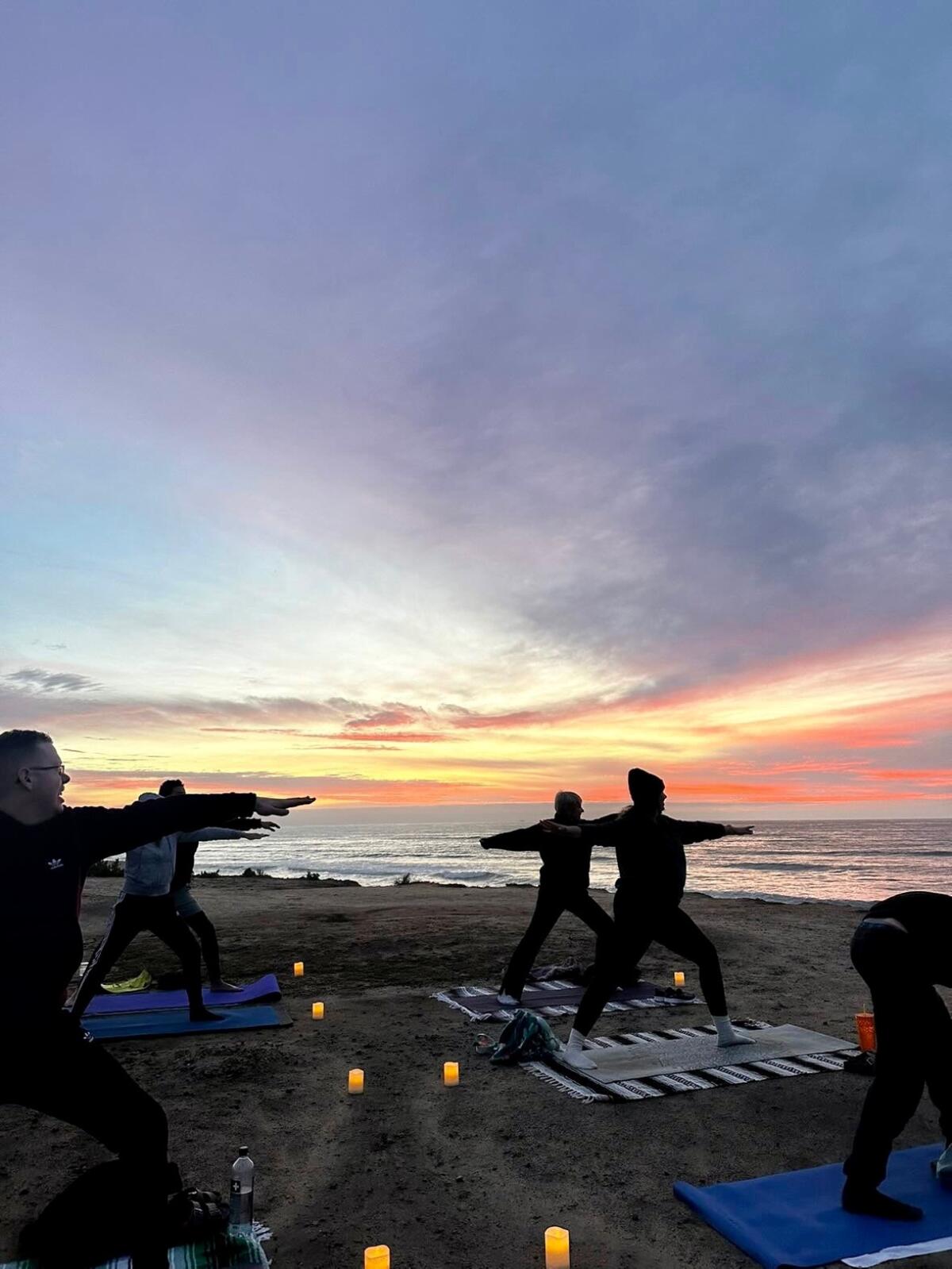 The sun sets over a yoga class at Sunset Cliffs Nature Park in San Diego 
