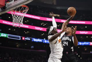 Los Angeles Clippers guard Norman Powell, right, attempts to dunk past Denver Nuggets guard Reggie Jackson during the second half of an NBA basketball game Wednesday, Dec. 6, 2023, in Los Angeles. (AP Photo/Ryan Sun)