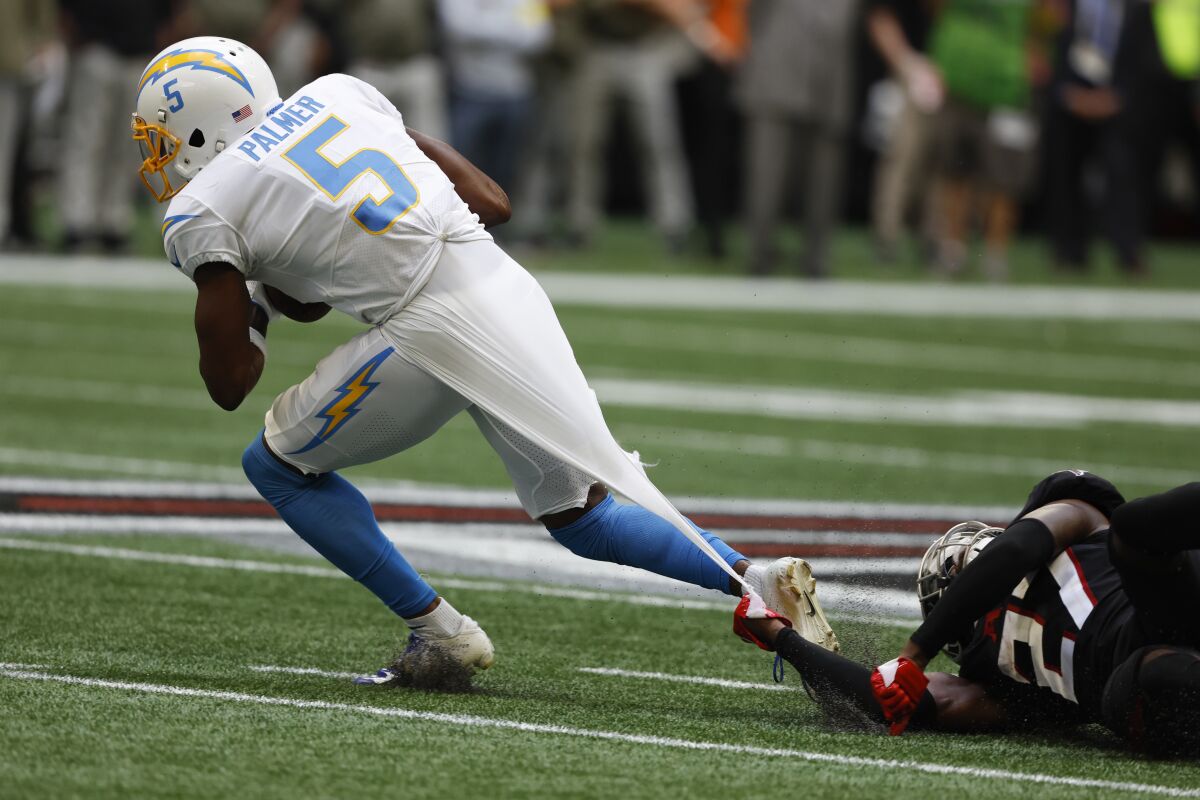 Falcons safety Richie Grant (27) grabs the shirt of Chargers receiver Joshua Palmer (5).