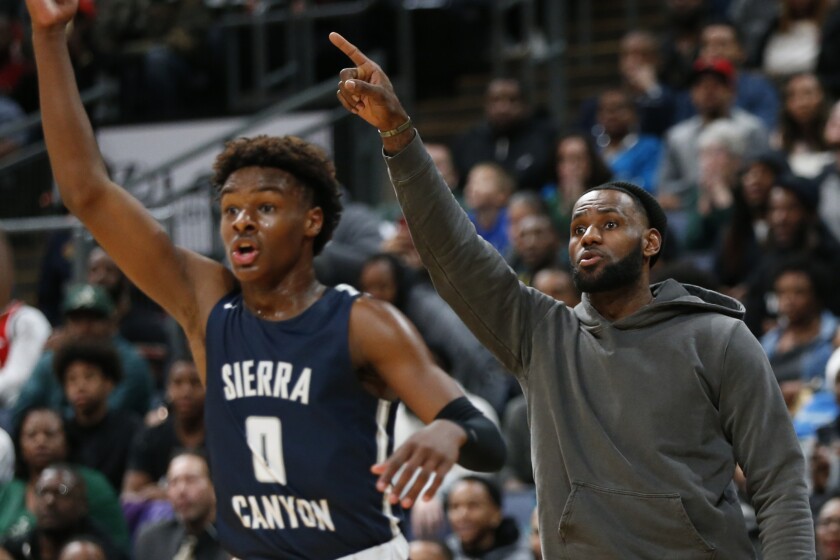 LeBron James reacts from the sideline as his son Bronny (0) plays against his alma mater on Dec. 14, 2019, in Columbus, Ohio.