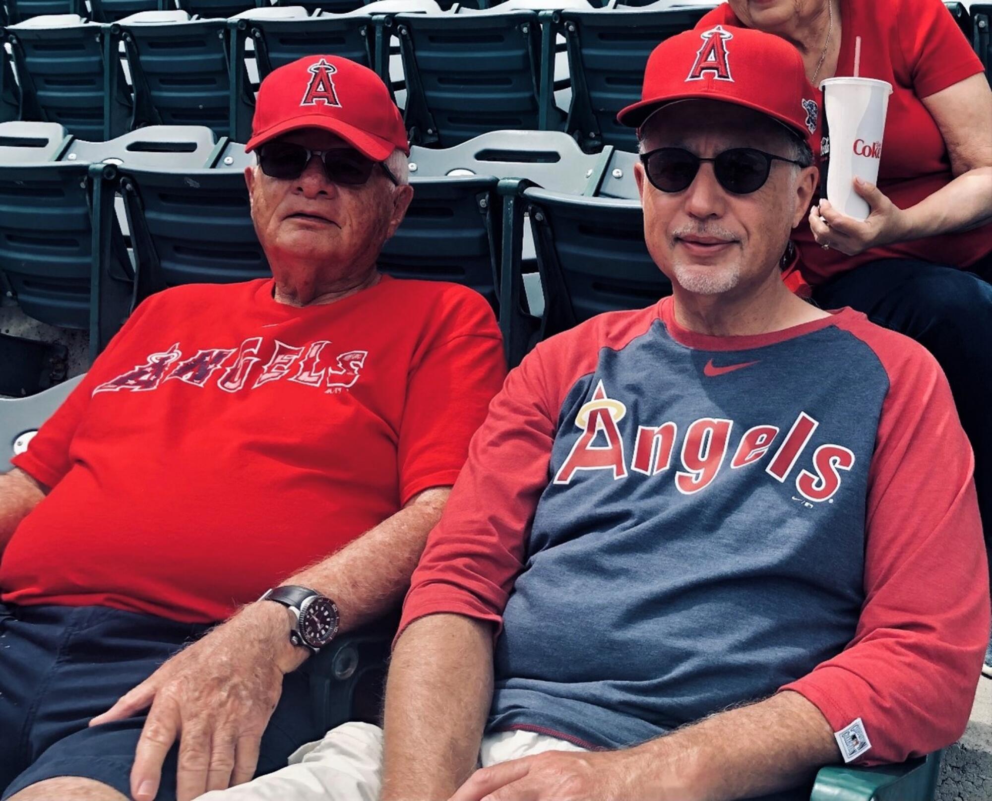 Hal Hyman, left, and son Bradley enjoy an Angels game together.