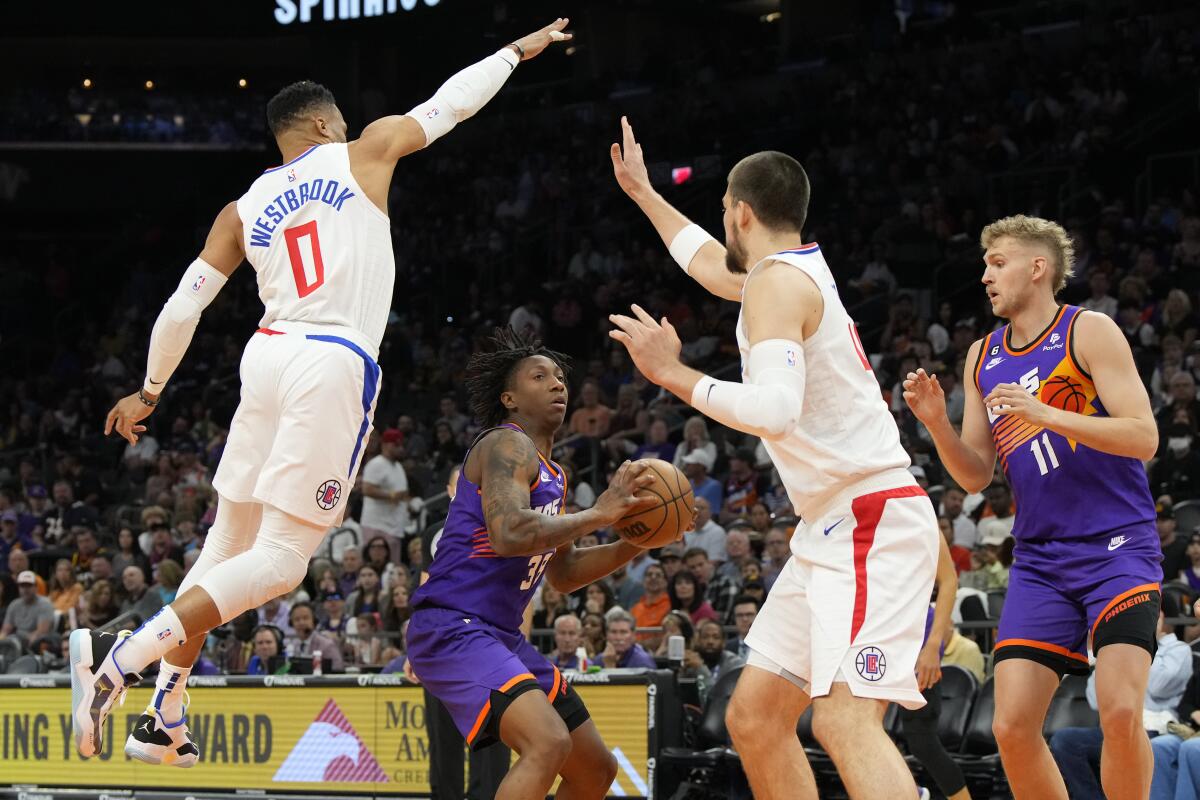 Suns guard Saben Lee looks to score in the lane against Clippers guard Russell Westbrook and center Ivica Zubac.