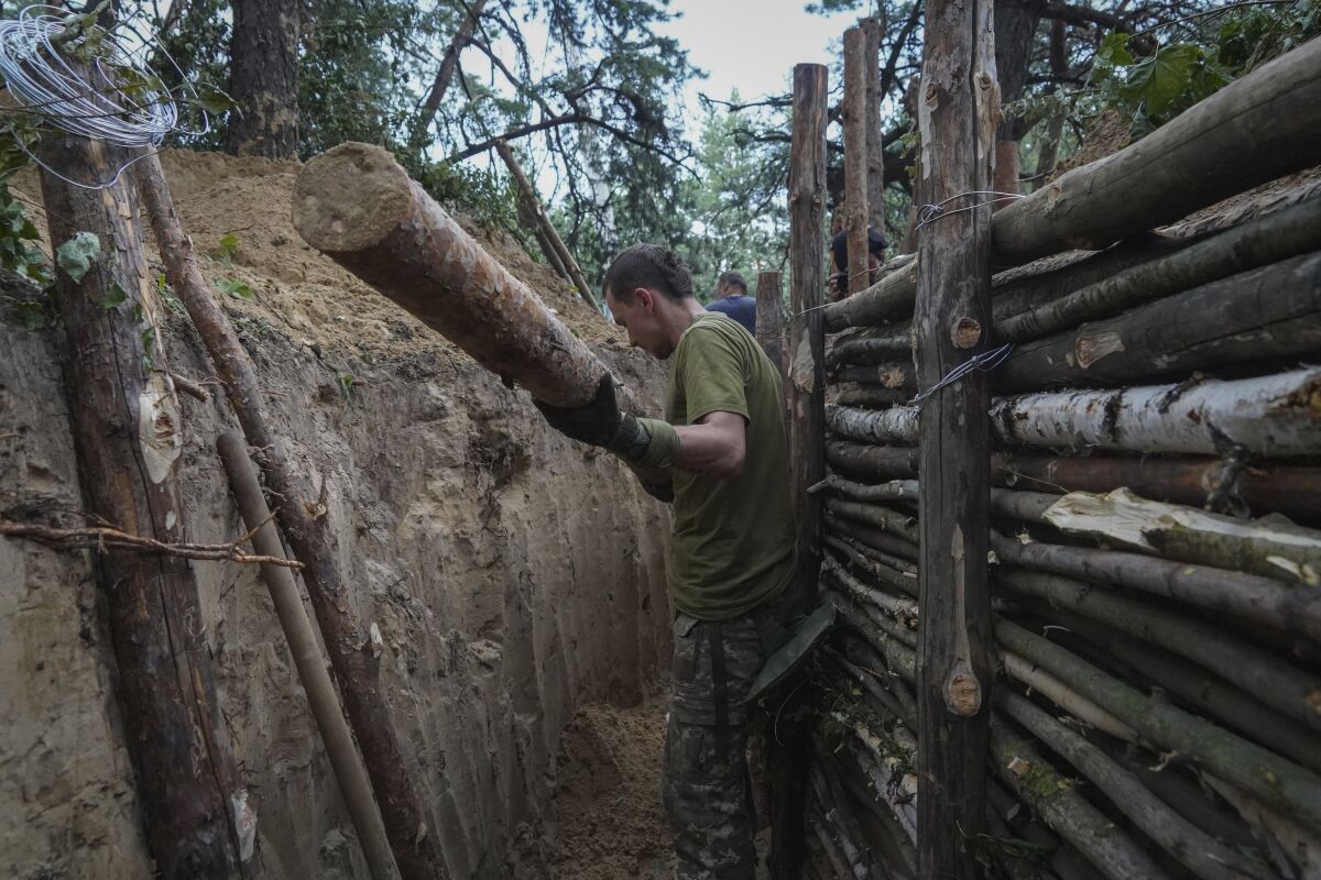 Ukrainian servicemen strengthen trenches on their position near the frontline in Kharkiv region, Ukraine, Tuesday, July, 5, 2022. (AP Photo/Andrii Marienko)