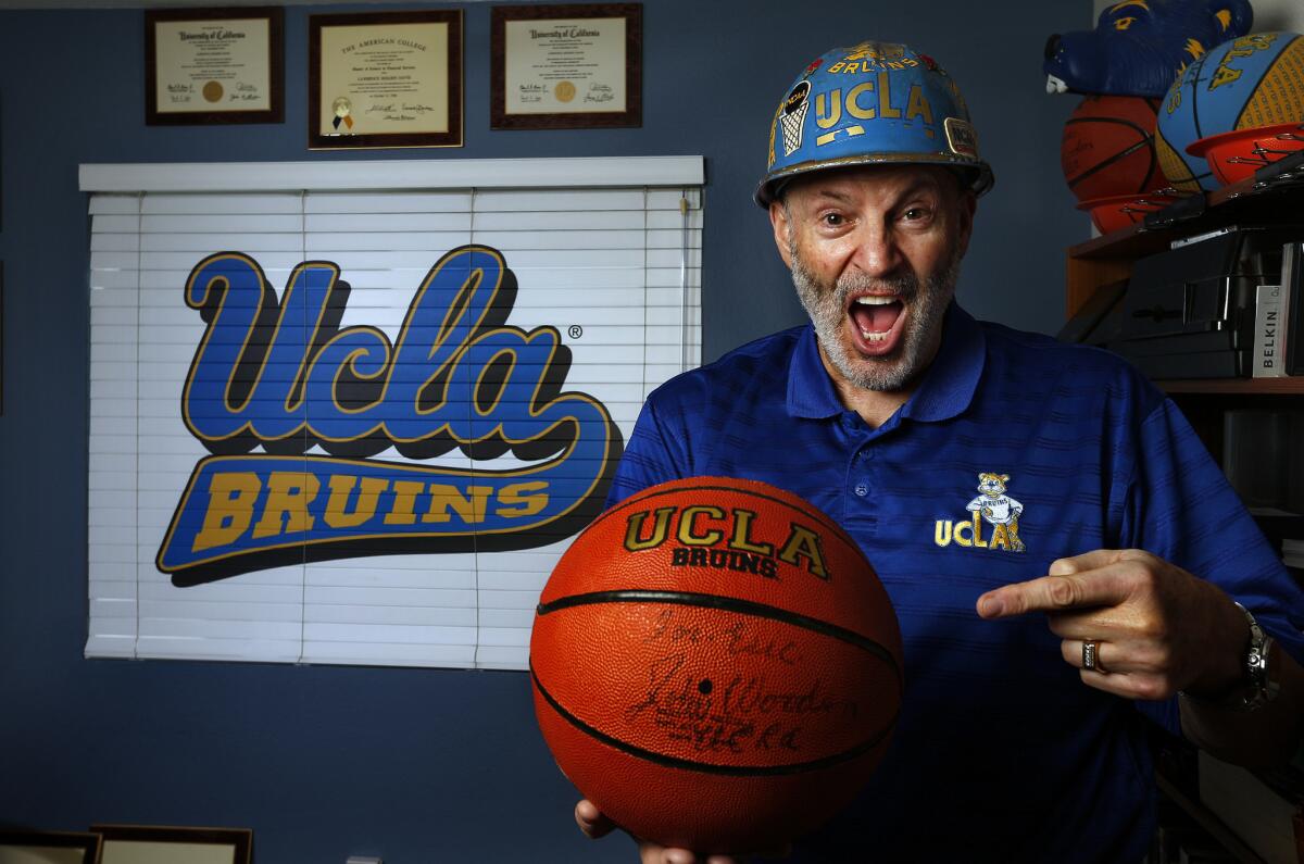 Larry "Frisbee" Davis, who as a student created an iconic UCLA sports cheer 40 years ago, is seen at his home in Porter Ranch. Davis doesn't care for the way the cheer is performed nowadays.