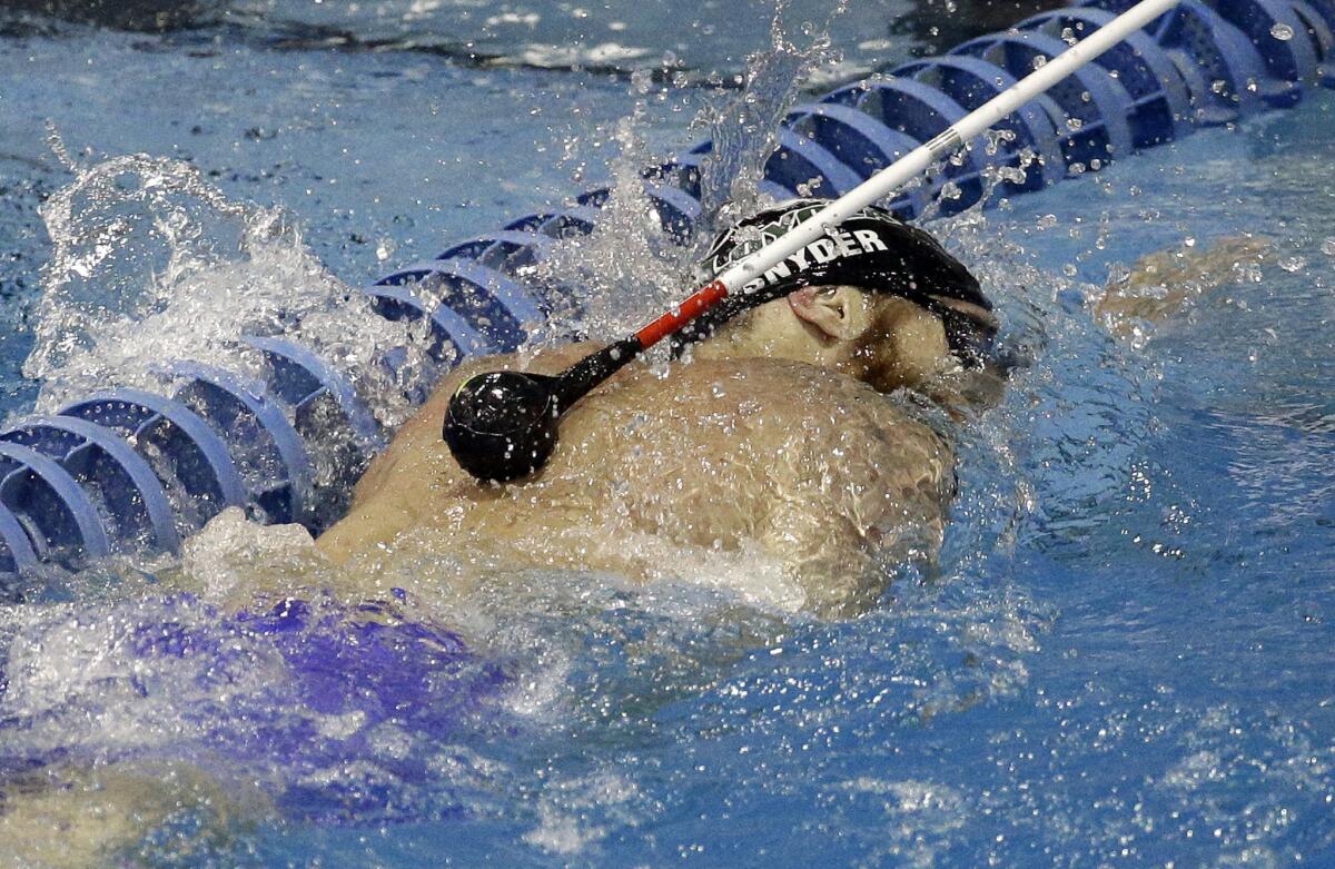 Brad Snyder receives a tap on the back by a volunteer to alert him he is approaching the wall for a turn during a 400-meter freestyle race.