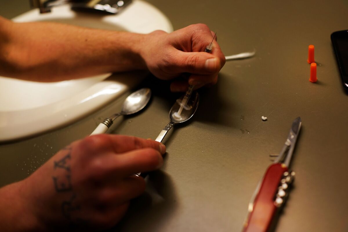 Fatal heroin overdoses rose 35% to 5,927 in 2012, according to U.S. government statistics. Above, a drug user prepares heroin.