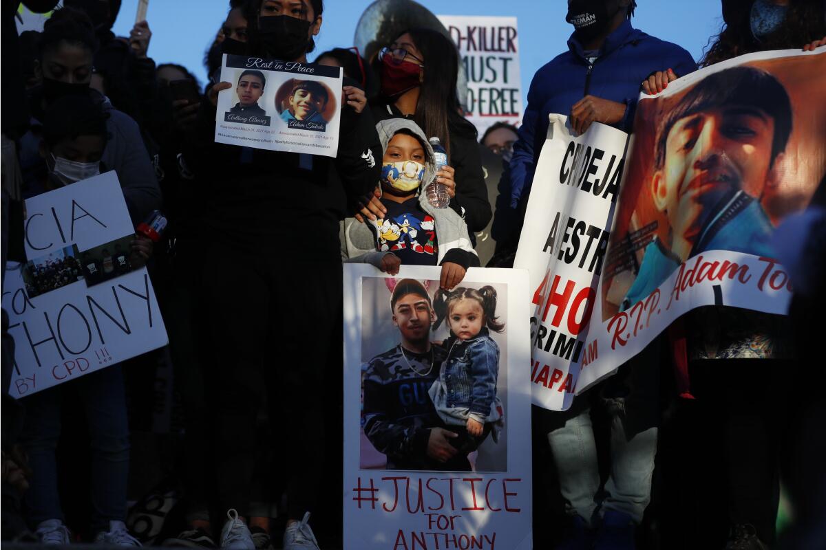 Demonstrators protest the shooting of 13-year-old Adam Toledo, Friday, April 16, 2021, in Logan Park in Chicago. (AP Photo/Shafkat Anowar)