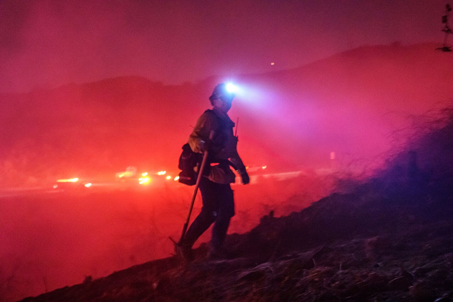 A firefighter surveys the scene near the Castlewood fire.