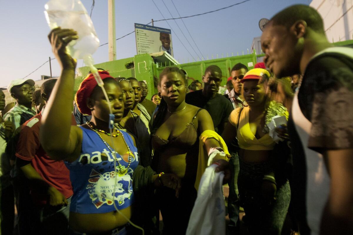 Injured revelers wait outside General Hospital in Port-au-Prince, Haiti, on Feb. 17, after a power-line accident at a Carnival parade.