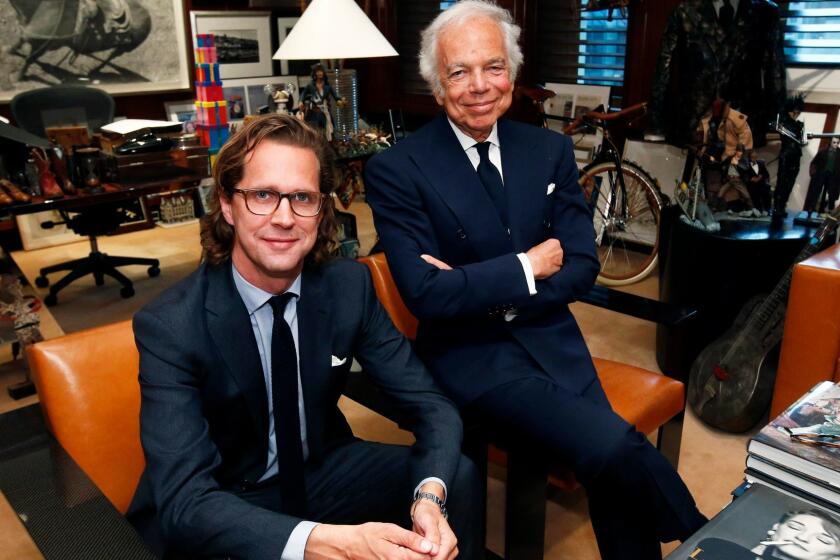 Designer Ralph Lauren, right, poses in his office with Stefan Larsson.