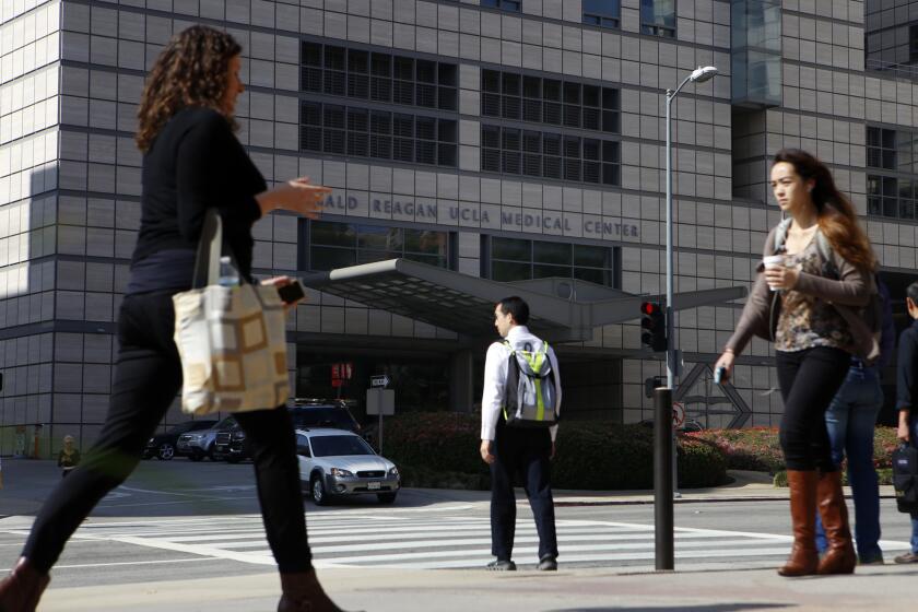 Pedestrians walk near Ronald Reagan UCLA Medical Center in February 2015. when a superbug outbreak sickened patients, including three who died.