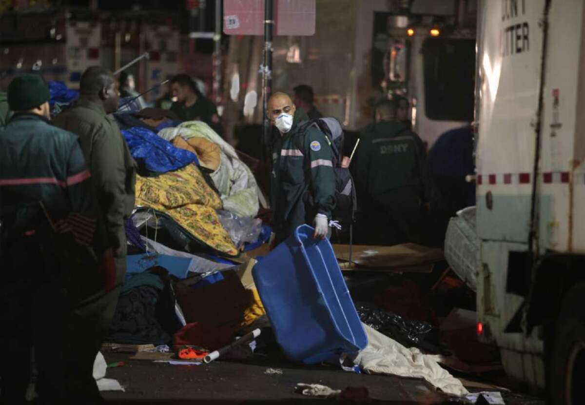 New York sanitation workers remove debris and belongings left by protesters of Occupy Wall Street from Zuccotti Park during a nighttime raid on Nov. 15, 2011.