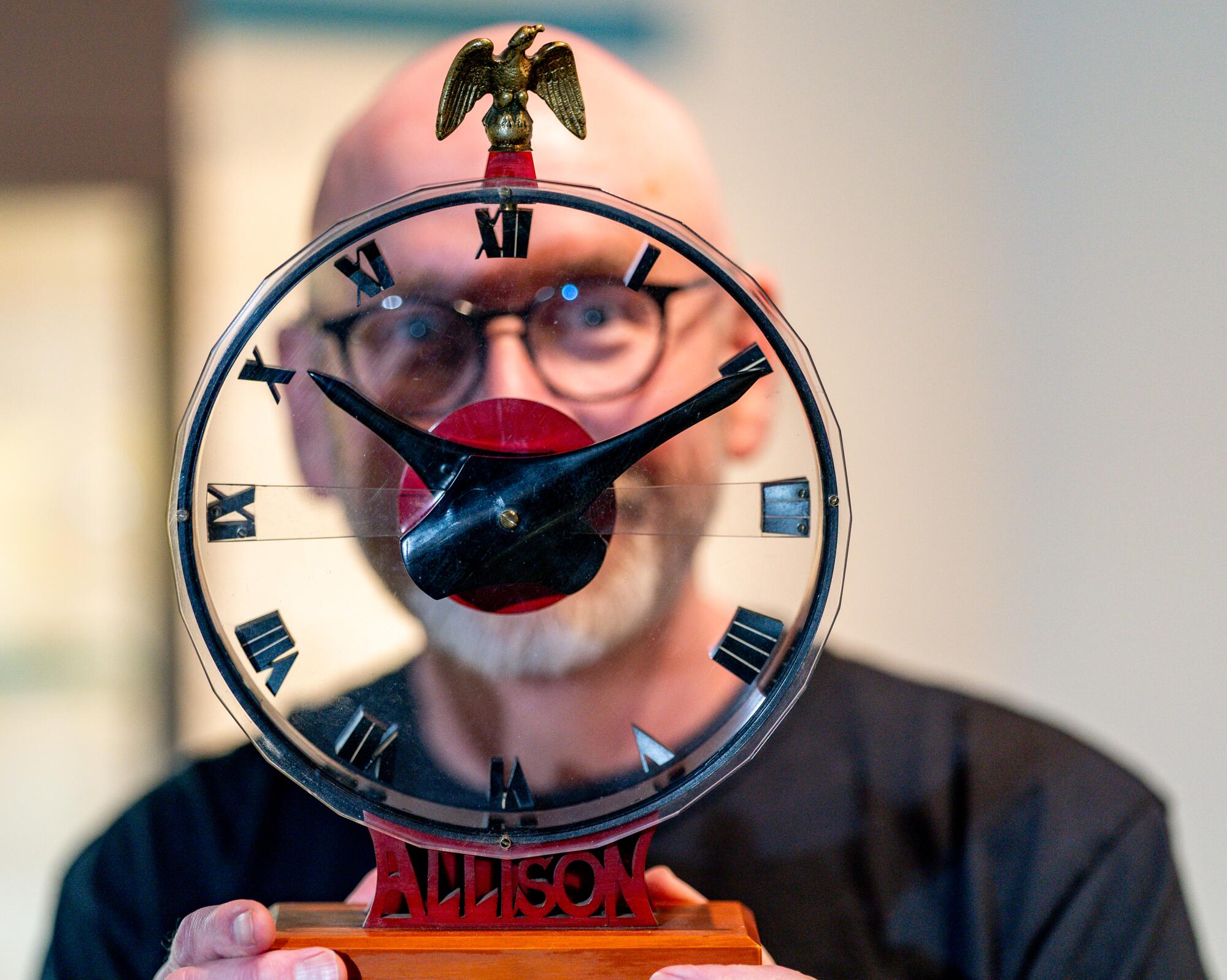 Greg Allison displays the Mystery Clock.