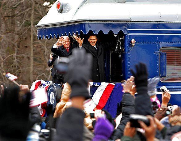 President-elect Barack Obama and Vice President-elect Joe Biden wave from their train as they pass through Edgewood, Md., on a pre-inauguration whistle-stop train tour.