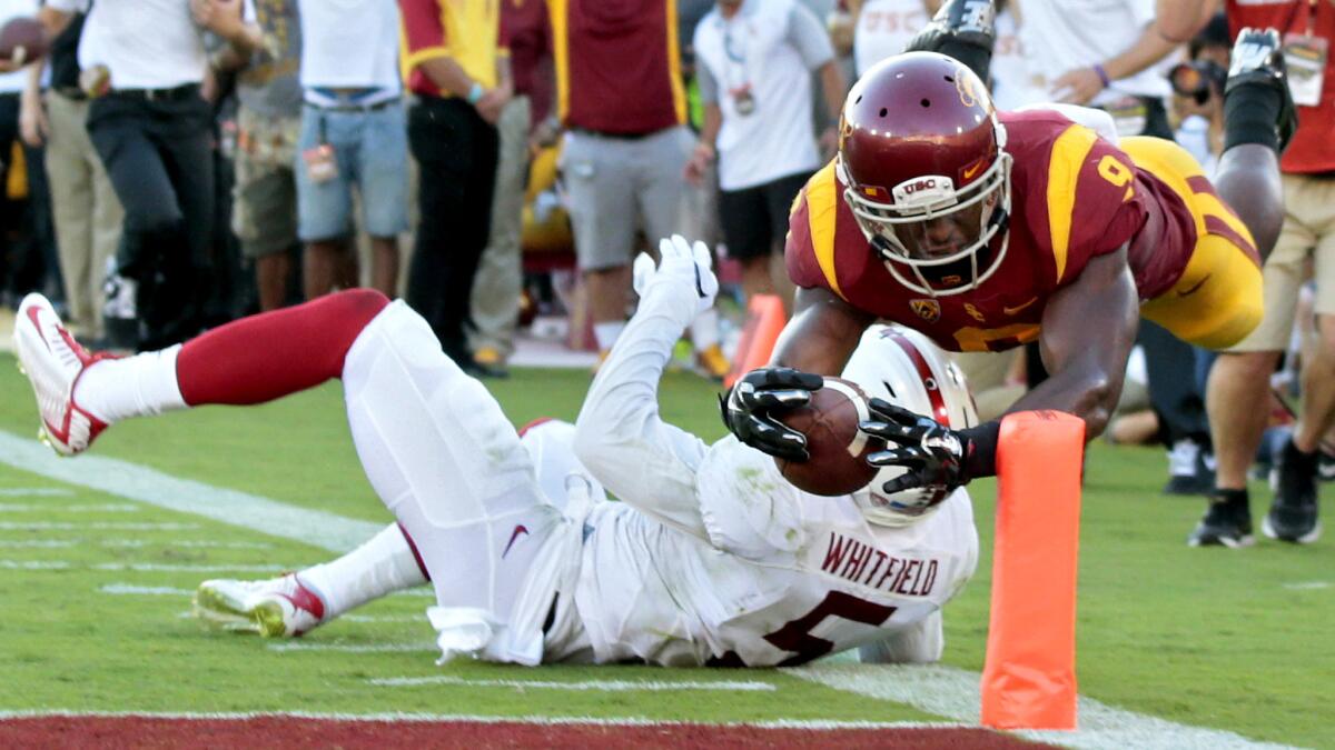 USC receiver Juju Smith-Schuster dives to the pylon over Stanford safety Kodi Whitfield for a touchdown in the second quarter Saturday evening at the Coliseum.