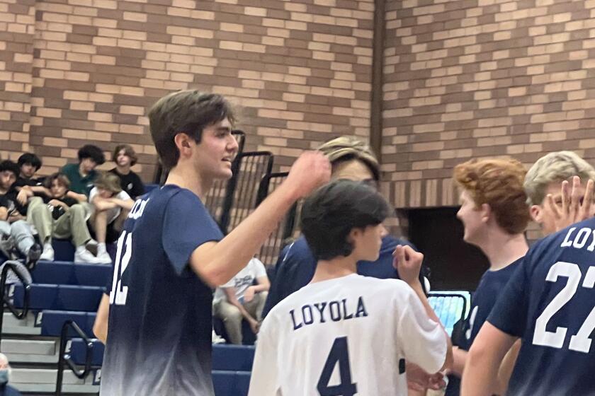 Sean Kelly (left) celebrates with his teammates after getting 21 kills for Loyola in volleyball playoff win over Edison.
