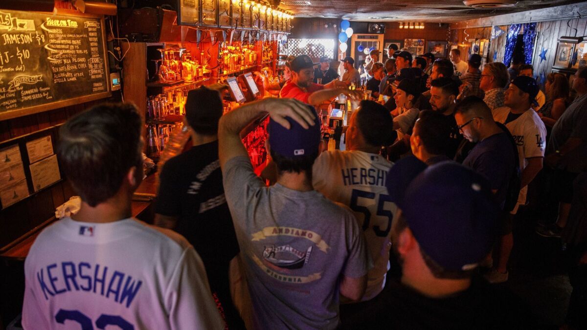 Dodgers fans gather at The Short Stop bar in Echo Park before World Series Game 3 game against the Boston Red Sox.