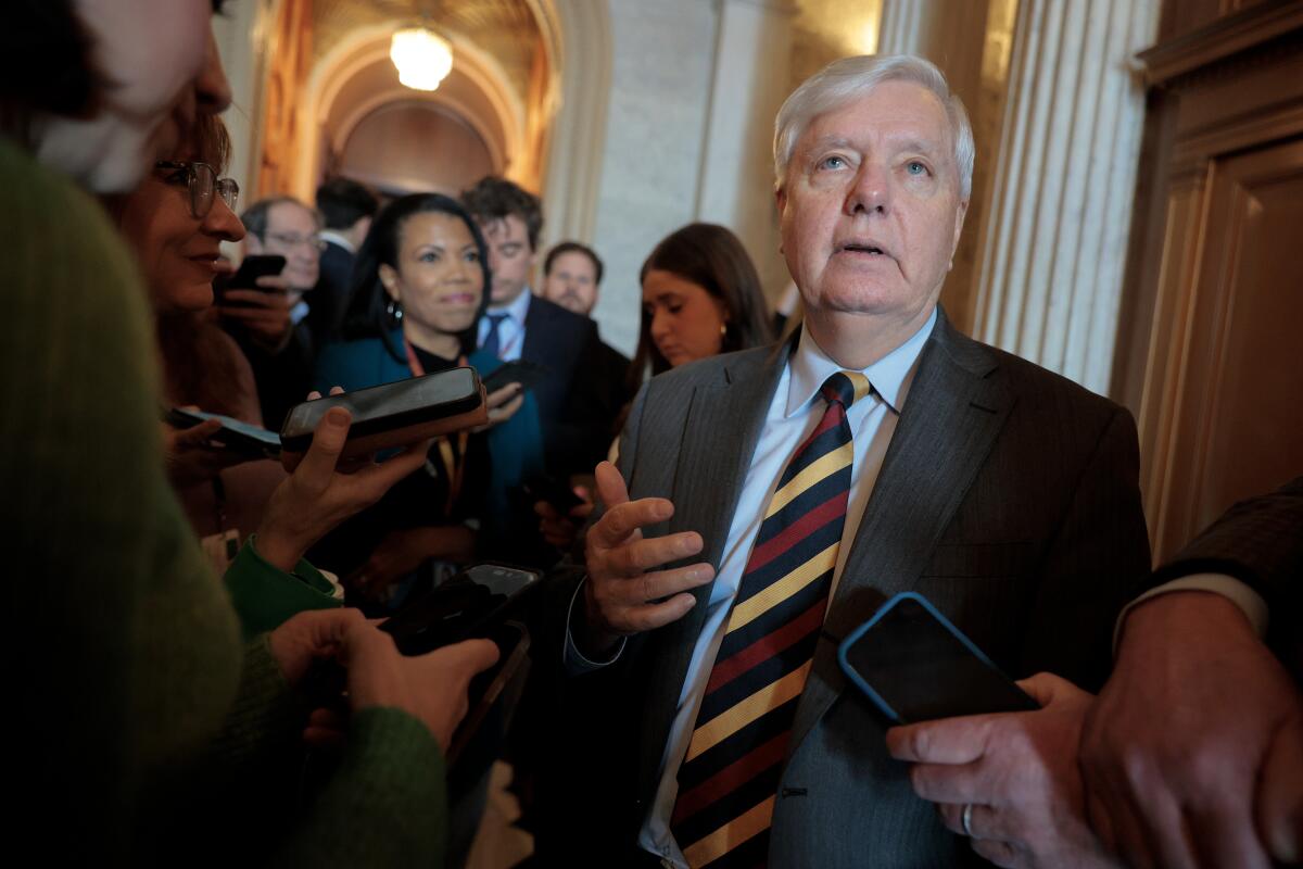 Sen. Lindsey Graham talks to reporters after holding up legislation aimed at heading off a prolonged government shutdown.