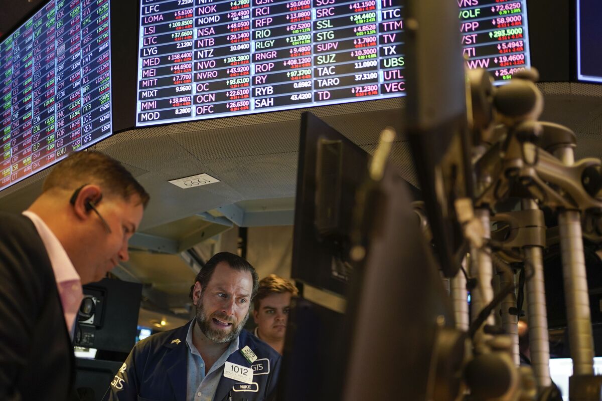 Traders look at a computer on the floor at the New York Stock Exchange. 