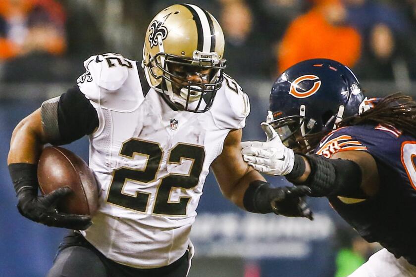 New Orleans Saints running back Mark Ingram, left, breaks away from Chicago Bears defensive end Willie Young during the Saints' 31-15 win Monday.